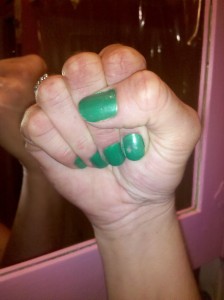 Photo of woman's fist with green nail polish